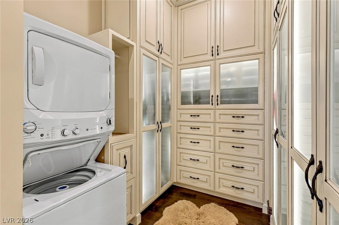 7 Lido Nord, Henderson, NV 89011 Floor-to-ceiling custom cabinetry with integrated glass panel doors surrounds a convenient stacked laundry station.