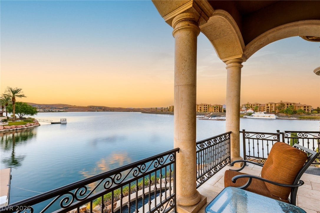 7 Lido Nord, Henderson, NV 89011 Sweeping water vistas unfurl beyond stone arches and elegant wrought-iron railings on this private balcony.