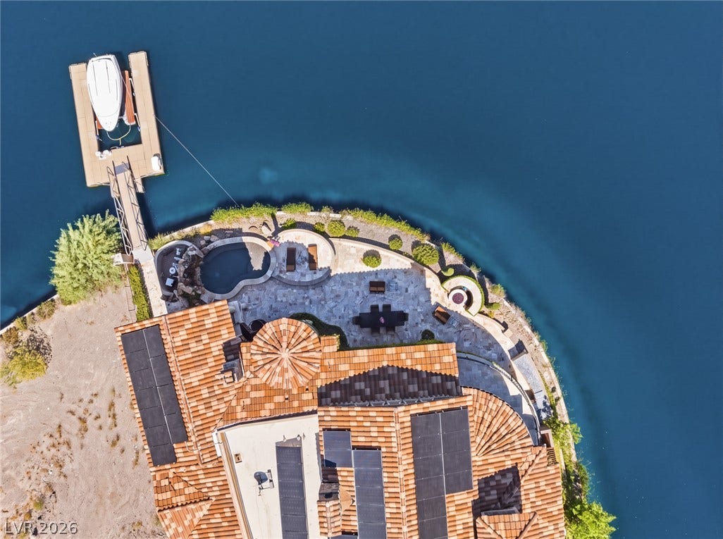 7 Lido Nord, Henderson, NV 89011 An aerial perspective reveals a prime waterfront property complete with a private dock and stone patio.
