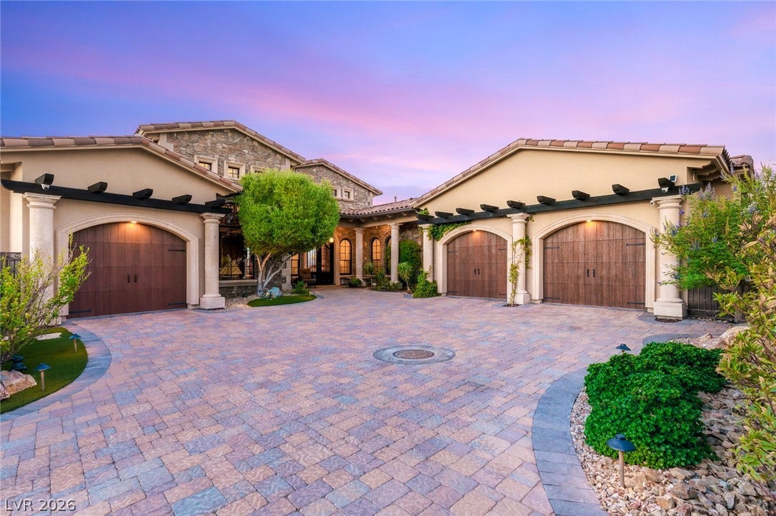 7 Lido Nord, Henderson, NV 89011 An expansive paver driveway leads to three garage bays under classic tile roofing.