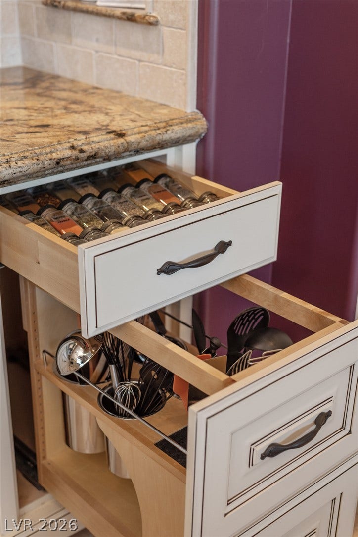 7 Lido Nord, Henderson, NV 89011 Custom pull-out drawers provide smart organization beneath thick granite countertops.