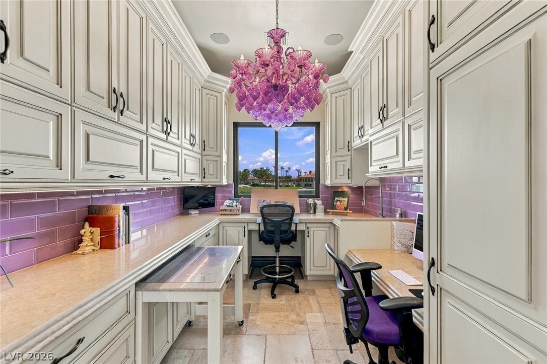 7 Lido Nord, Henderson, NV 89011 Floor-to-ceiling cabinetry and stone work surfaces define this custom home office space.