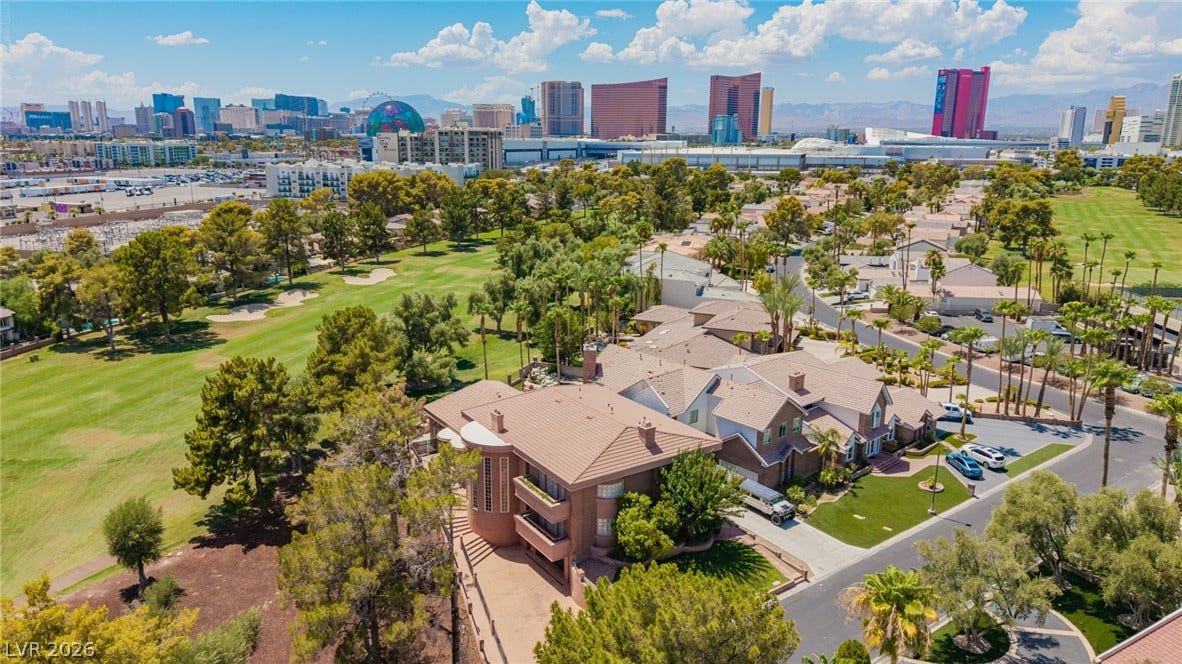 1105 Broadmoor Avenue, Las Vegas, NV 89109 An aerial perspective captures this multi-level home lining a golf course with city skyline views.