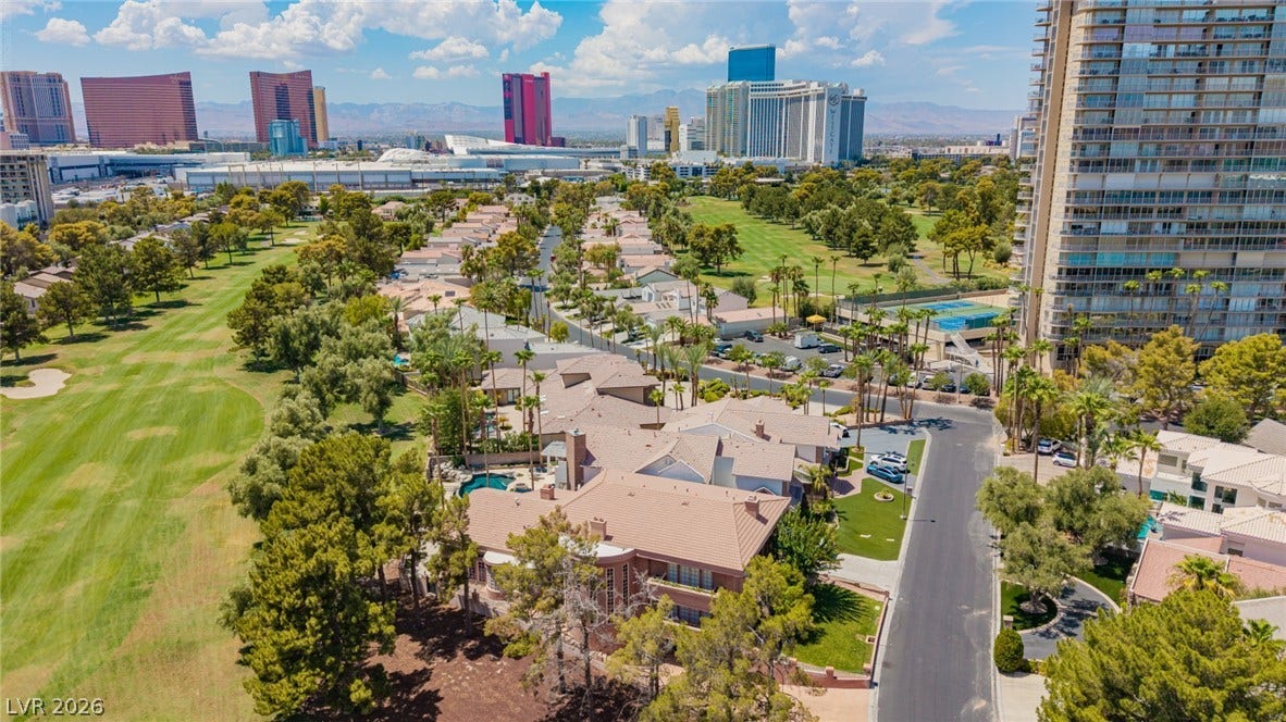 1105 Broadmoor Avenue, Las Vegas, NV 89109 An aerial perspective showcases a quiet residential street bordering a verdant golf course landscape.