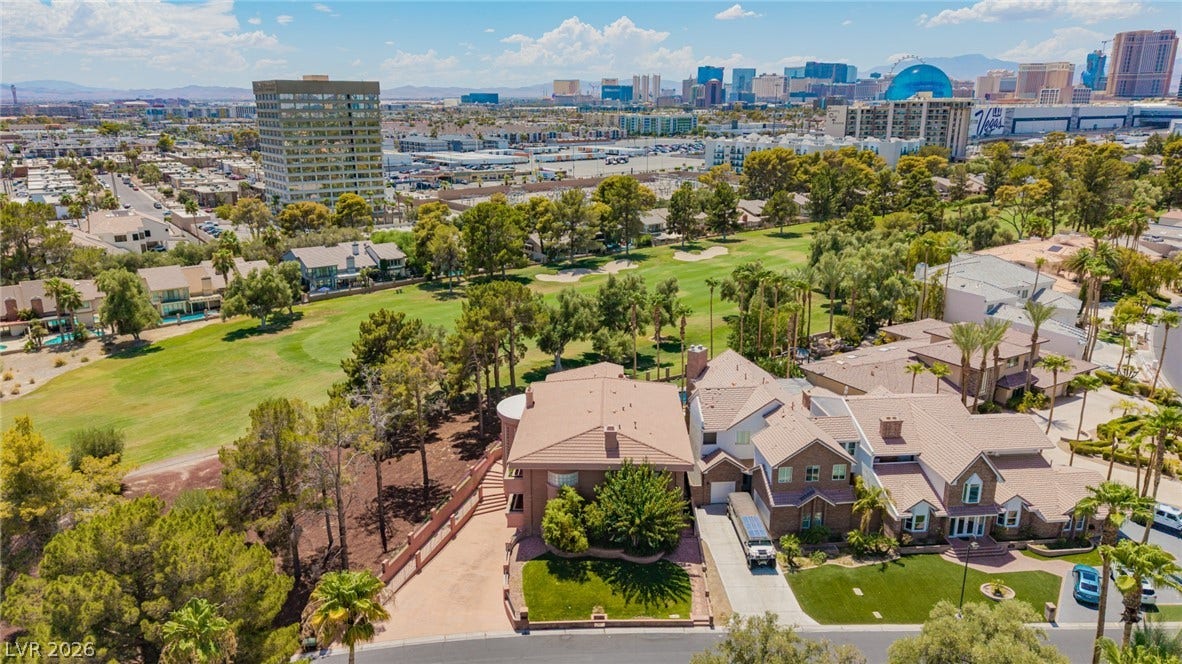 1105 Broadmoor Avenue, Las Vegas, NV 89109 An aerial perspective reveals the residential enclave bordering a manicured golf course under expansive skies.
