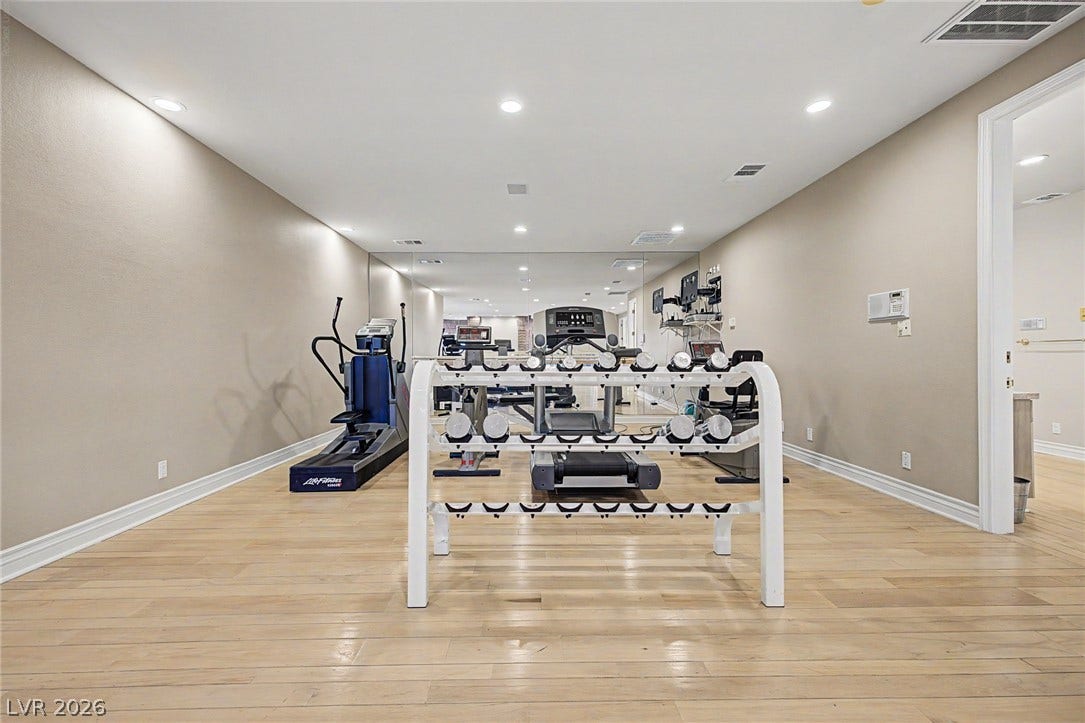1105 Broadmoor Avenue, Las Vegas, NV 89109 Recessed lighting illuminates this versatile home gym finished with clean hardwood flooring.