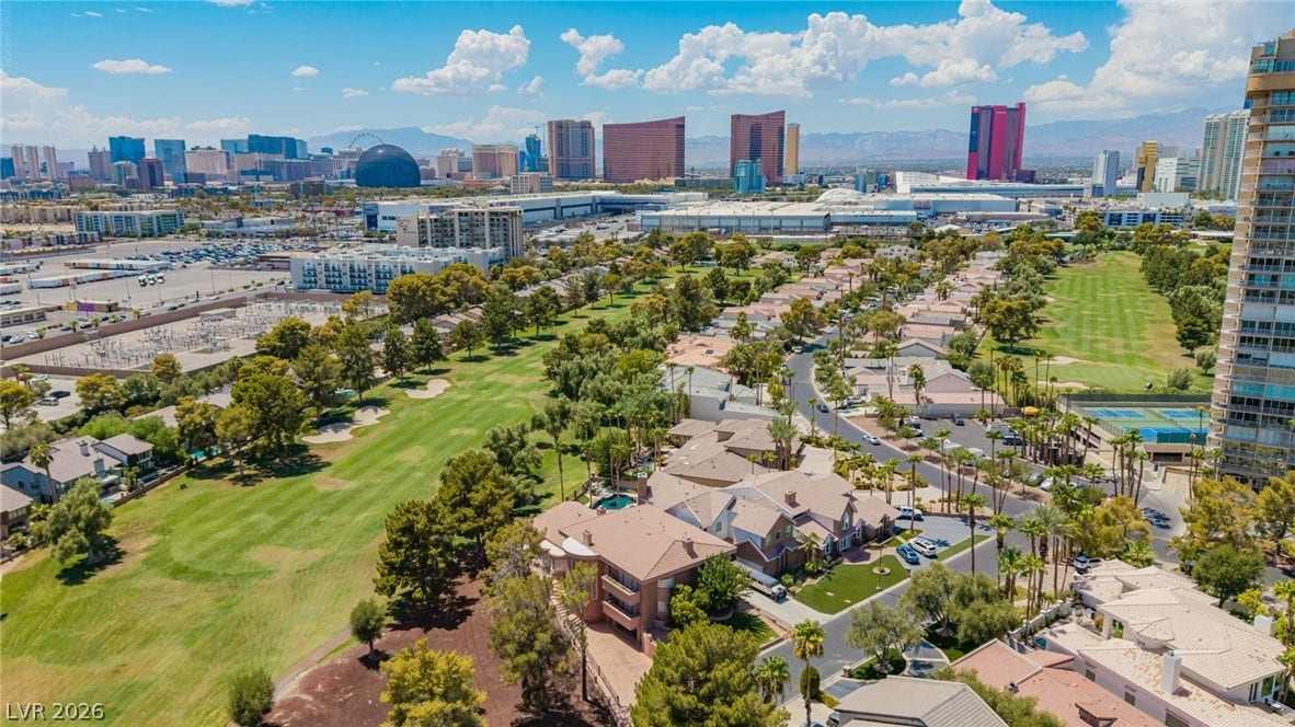 1105 Broadmoor Avenue, Las Vegas, NV 89109 Panoramic bird's-eye views encompass pristine golf fairways stretching toward a distant city skyline.