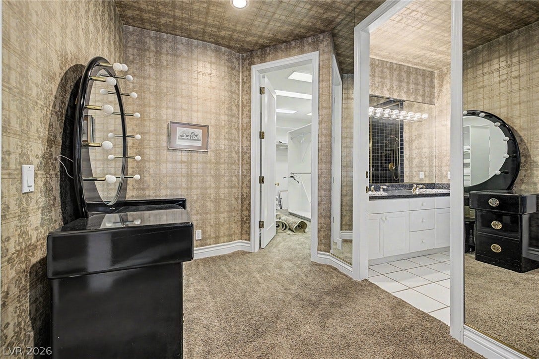 1105 Broadmoor Avenue, Las Vegas, NV 89109 Gilded wallpaper and plush carpeting bring refined texture to this dressing area and master suite entry.