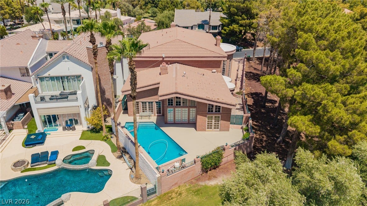 1105 Broadmoor Avenue, Las Vegas, NV 89109 An aerial perspective captures the backyard swimming pool alongside the multi-level residential structure.