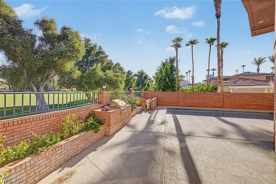 1105 Broadmoor Avenue, Las Vegas, NV 89109 An inviting backyard patio features built-in brick planters and an adjacent swimming pool.
