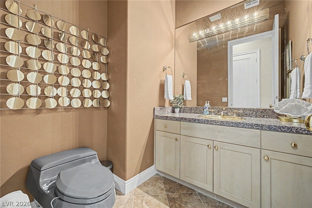 1105 Broadmoor Avenue, Las Vegas, NV 89109 A classic powder room highlights a granite-topped vanity and diagonal tile flooring.
