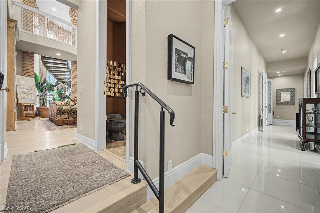 1105 Broadmoor Avenue, Las Vegas, NV 89109 Gleaming polished tile floors guide guests through a bright, multi-level hallway with soaring ceilings.