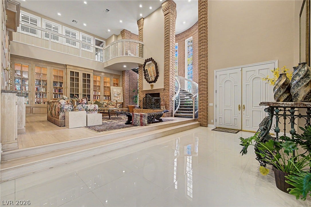 1105 Broadmoor Avenue, Las Vegas, NV 89109 Towering brick columns and a curved staircase define this dramatic, multi-level grand entryway.