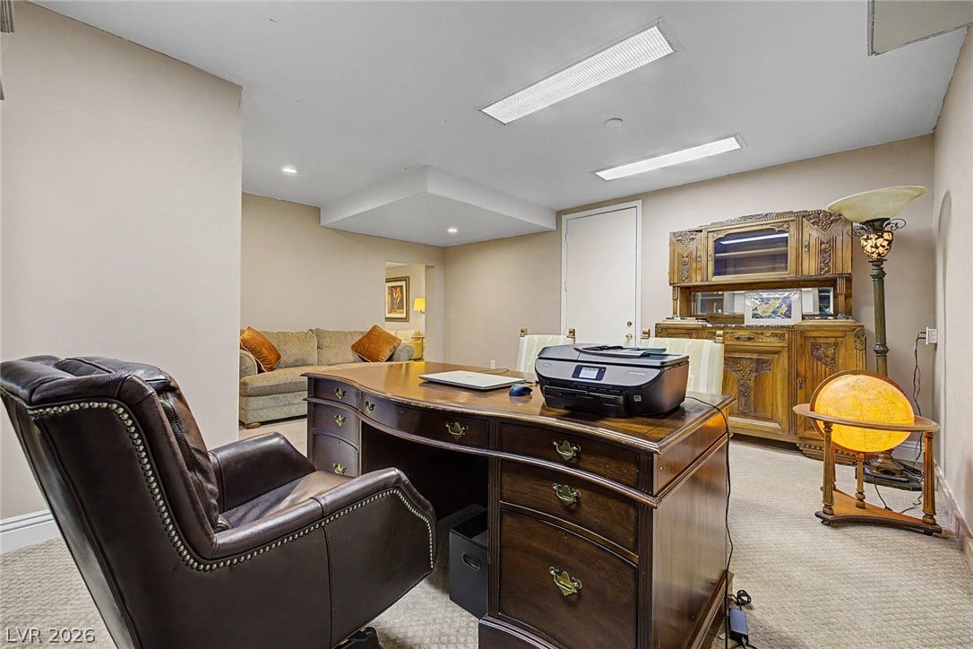 1105 Broadmoor Avenue, Las Vegas, NV 89109 Recessed and overhead fluorescent lighting brighten this carpeted home office workspace.
