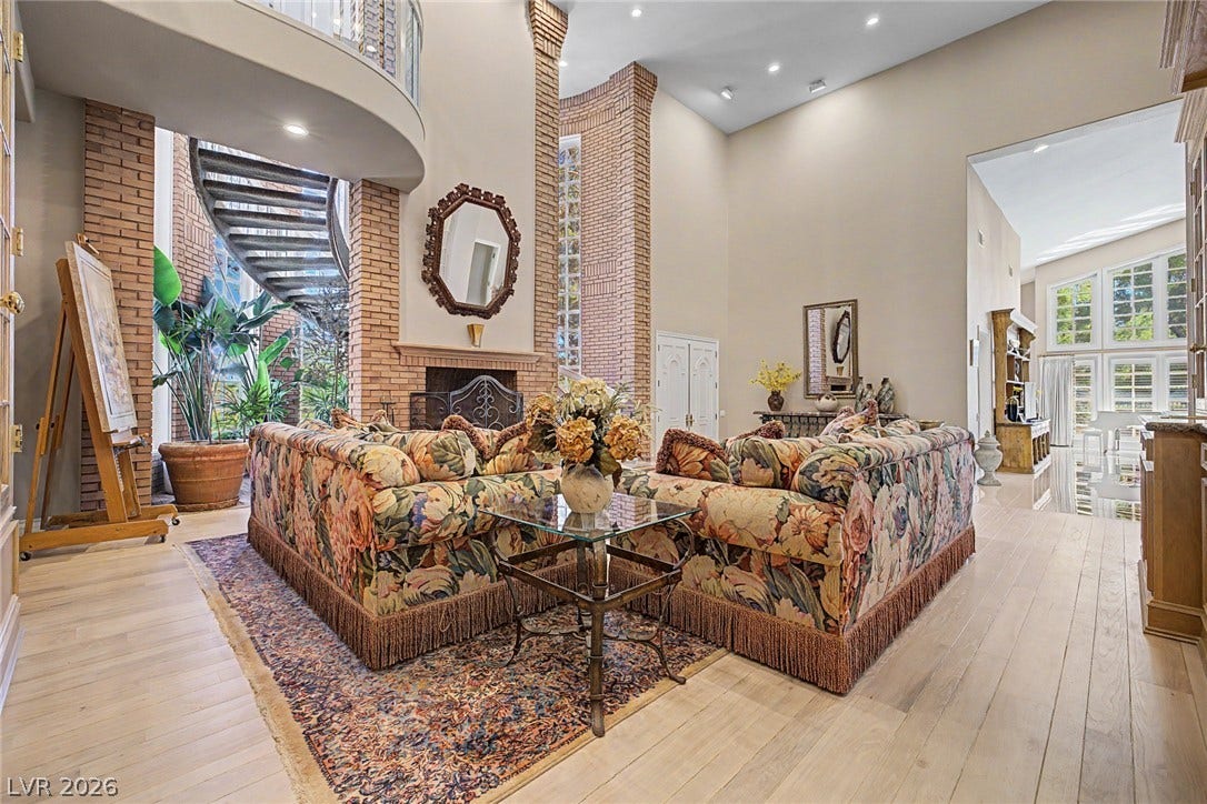 1105 Broadmoor Avenue, Las Vegas, NV 89109 Towering brick accents, a warm fireplace, and light wood flooring define this soaring living area.