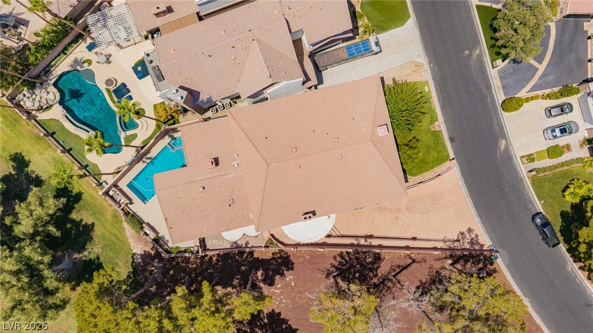 1105 Broadmoor Avenue, Las Vegas, NV 89109 An aerial perspective showcases the spacious lot, private swimming pool, and pristine tile roof.