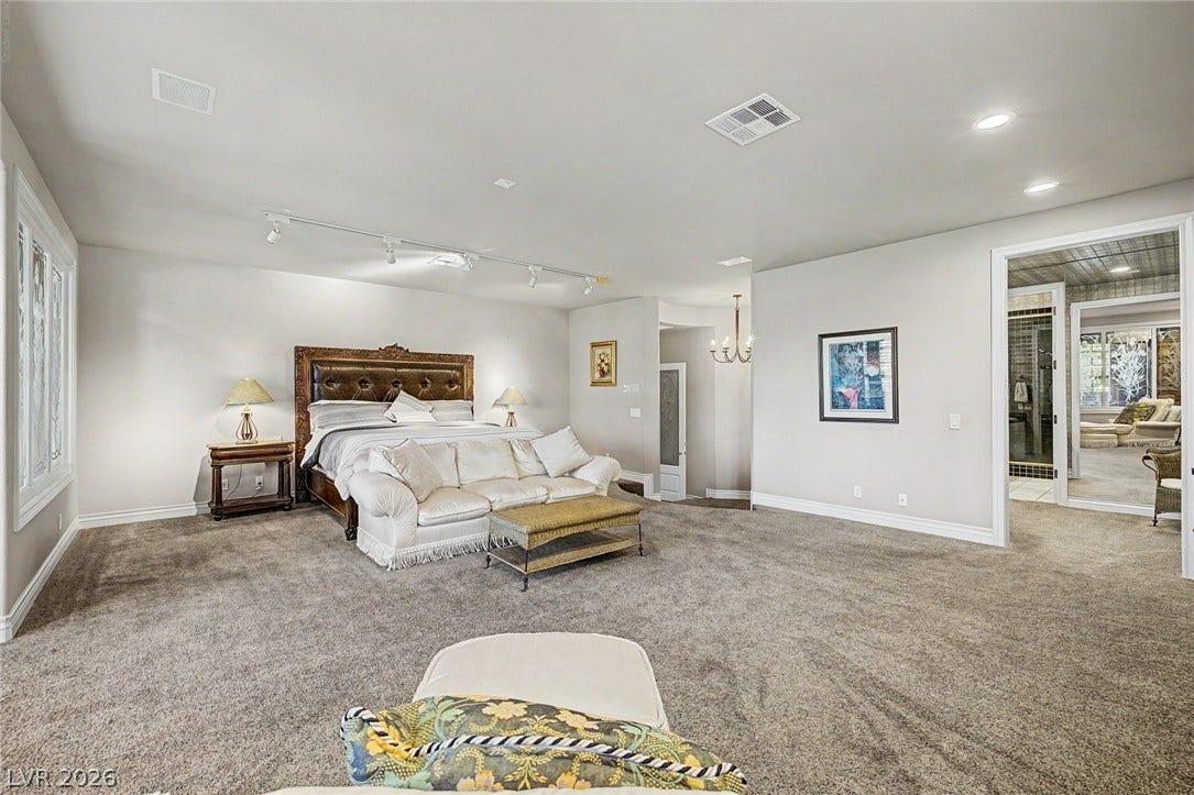 1105 Broadmoor Avenue, Las Vegas, NV 89109 Plush carpeting and recessed lighting create a comfortable, expansive main suite with attached bath access.