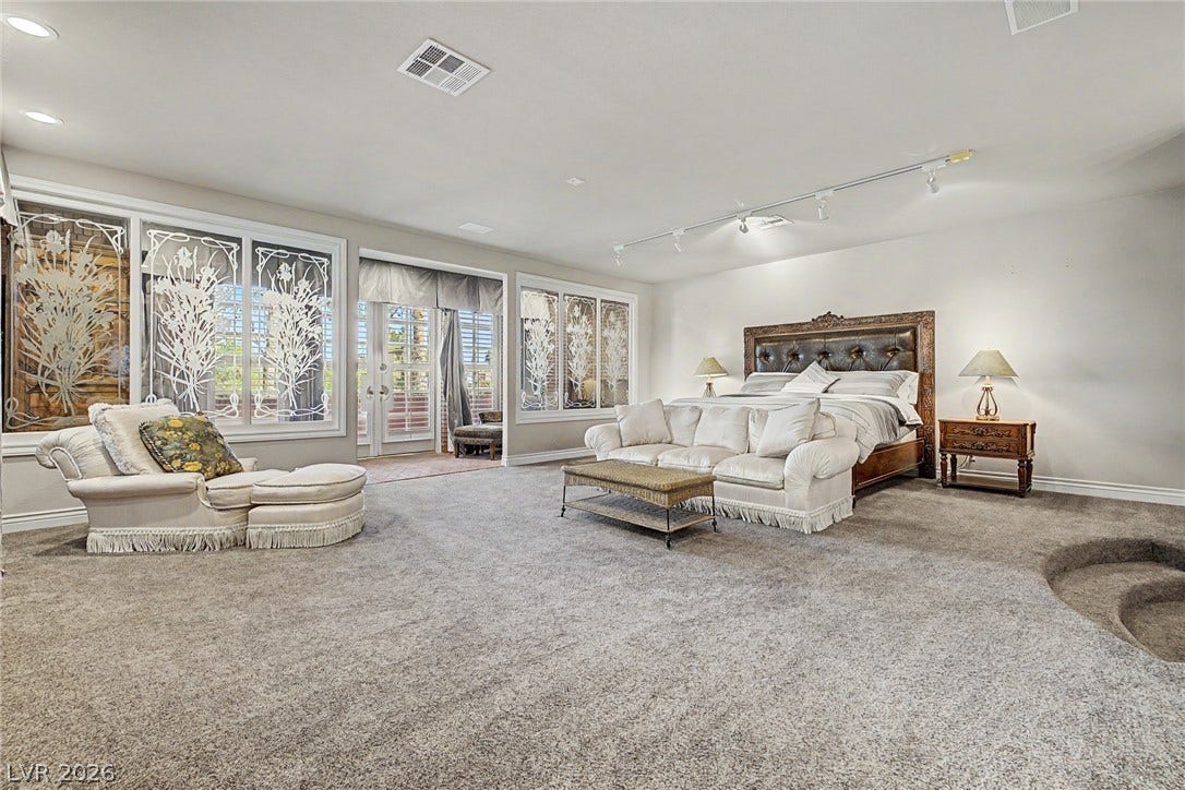 1105 Broadmoor Avenue, Las Vegas, NV 89109 Sunlight streams through unique etched glass windows into this generous bedroom with plush carpeting.