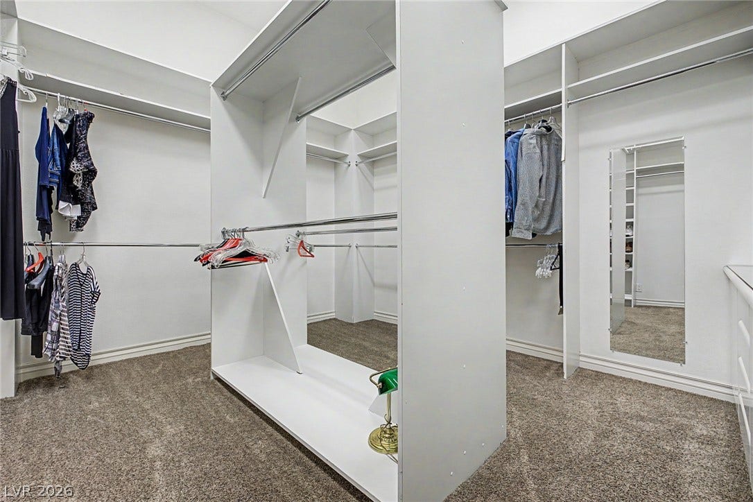 1105 Broadmoor Avenue, Las Vegas, NV 89109 A spacious walk-in closet boasts custom shelving and soft carpeting.