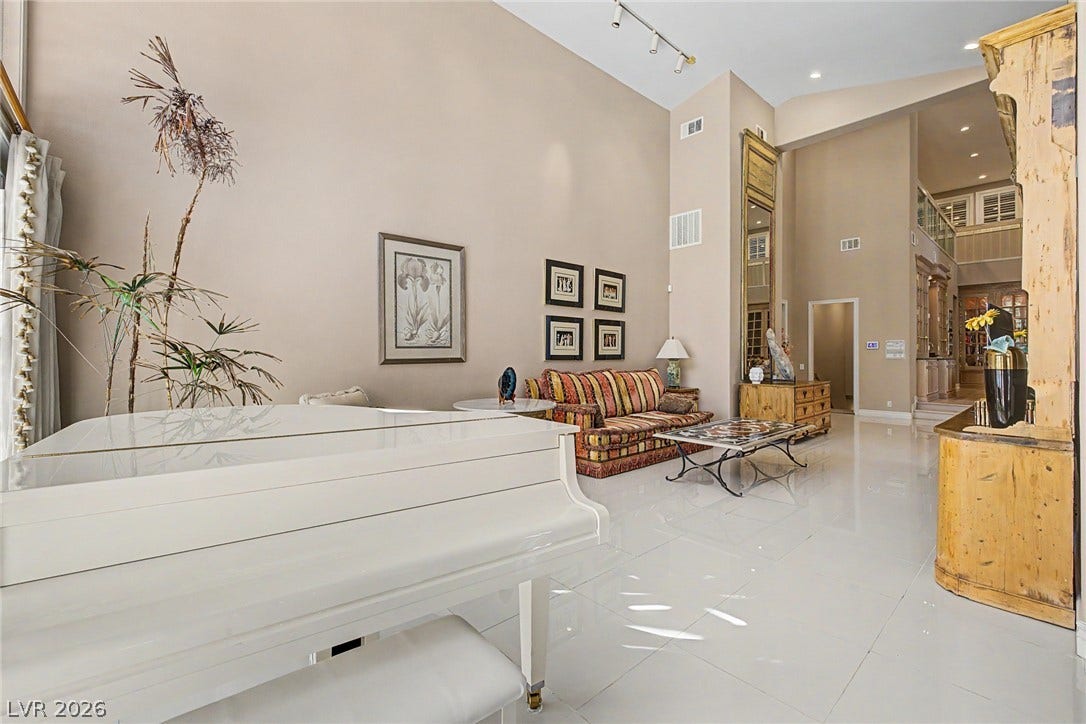 1105 Broadmoor Avenue, Las Vegas, NV 89109 Soaring ceilings and polished tile floors define this grand, open living area.