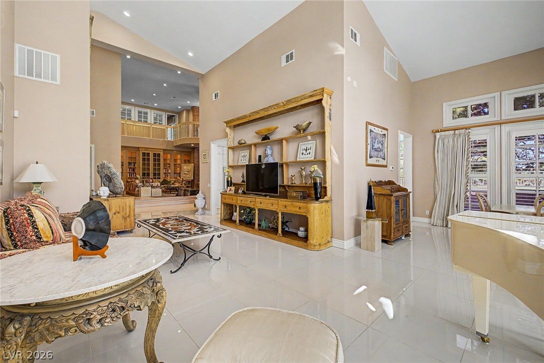 1105 Broadmoor Avenue, Las Vegas, NV 89109 Polished tile flooring and towering vaulted ceilings define this grand central living space.
