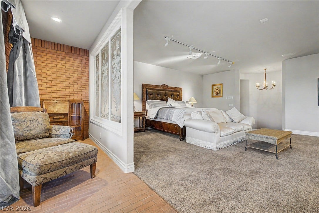 1105 Broadmoor Avenue, Las Vegas, NV 89109 An open bedroom suite connects seamlessly to an adjacent space featuring brick flooring.