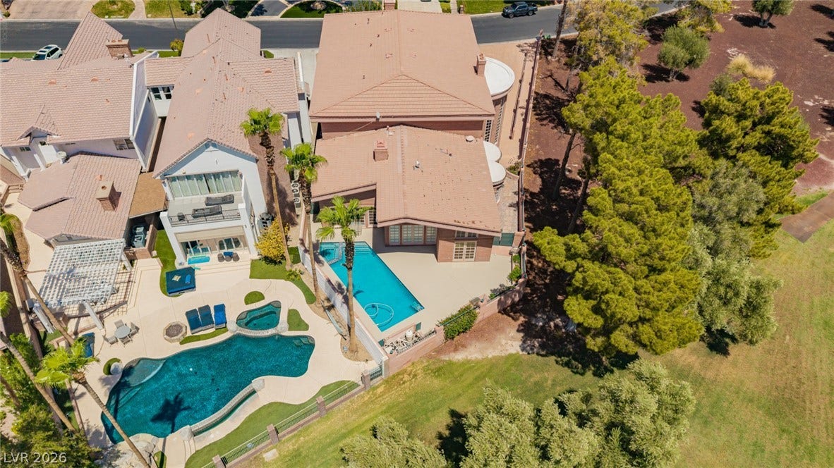 1105 Broadmoor Avenue, Las Vegas, NV 89109 An aerial perspective reveals tile roofs, private swimming pools, and mature backyard trees.