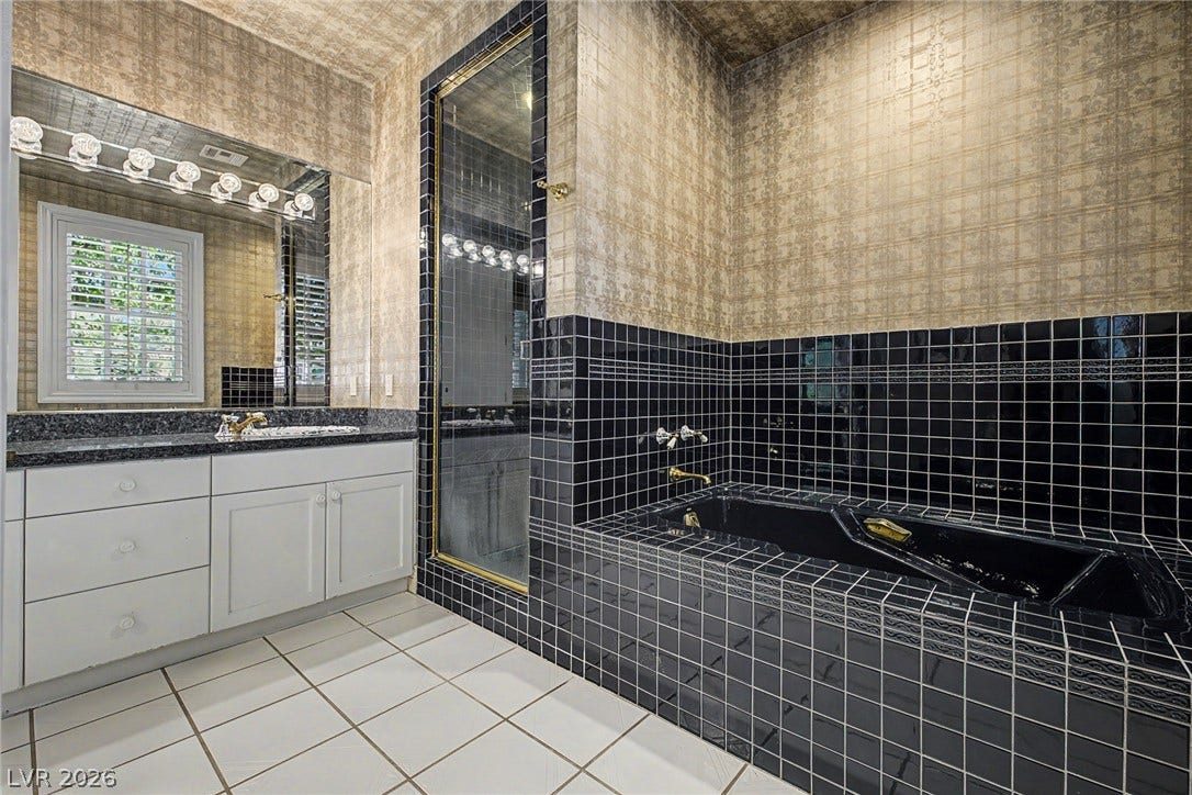 1105 Broadmoor Avenue, Las Vegas, NV 89109 Gleaming tile floors and a sunken tub establish a classic look in this bathroom.