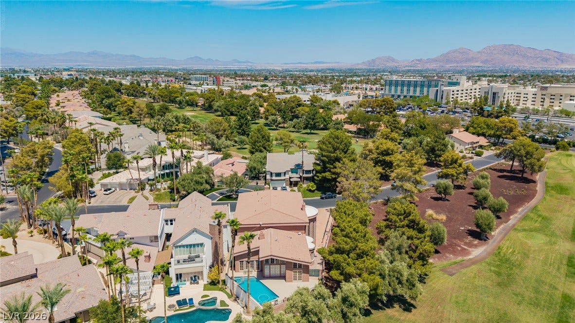 1105 Broadmoor Avenue, Las Vegas, NV 89109 A sweeping panorama captures this golf course community nestled against a distant mountain backdrop.
