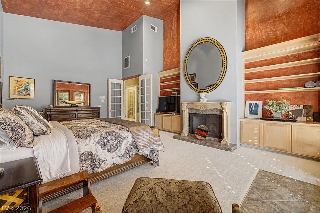 1105 Broadmoor Avenue, Las Vegas, NV 89109 Towering ceilings and a classic fireplace create an impressive sense of scale in this bedroom.