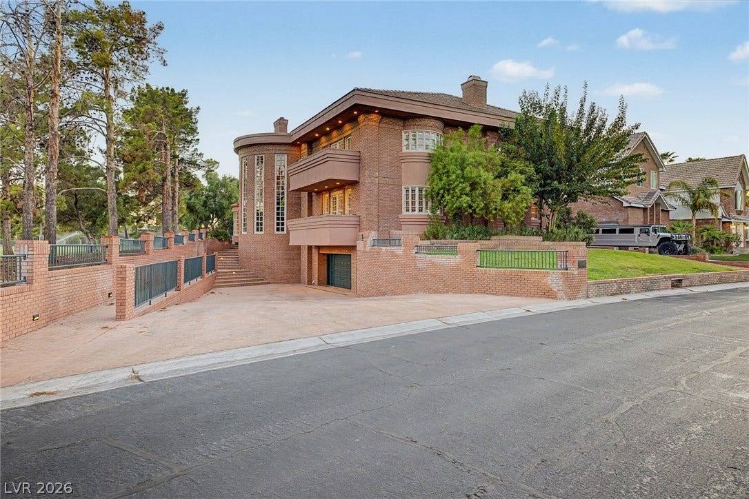 1105 Broadmoor Avenue, Las Vegas, NV 89109 A sweeping driveway leads past custom brickwork and multiple balconies of this impressive multi-level estate.