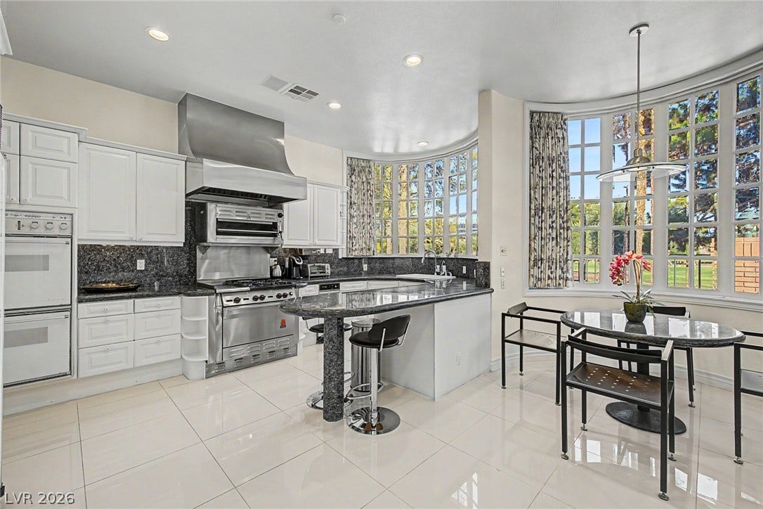 1105 Broadmoor Avenue, Las Vegas, NV 89109 Polished tile flooring and rounded bay windows define this spacious, light-filled kitchen area.