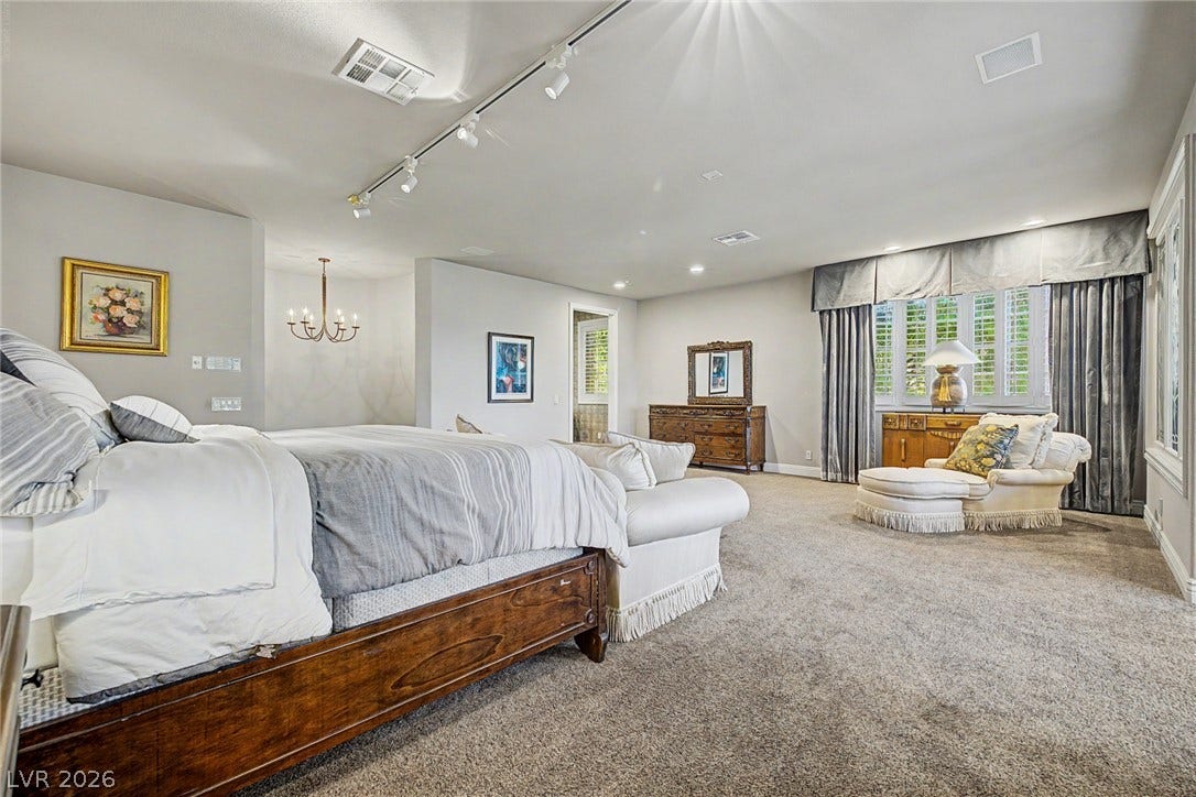 1105 Broadmoor Avenue, Las Vegas, NV 89109 Plush carpeting and dual light fixtures enhance this generously sized master bedroom suite.