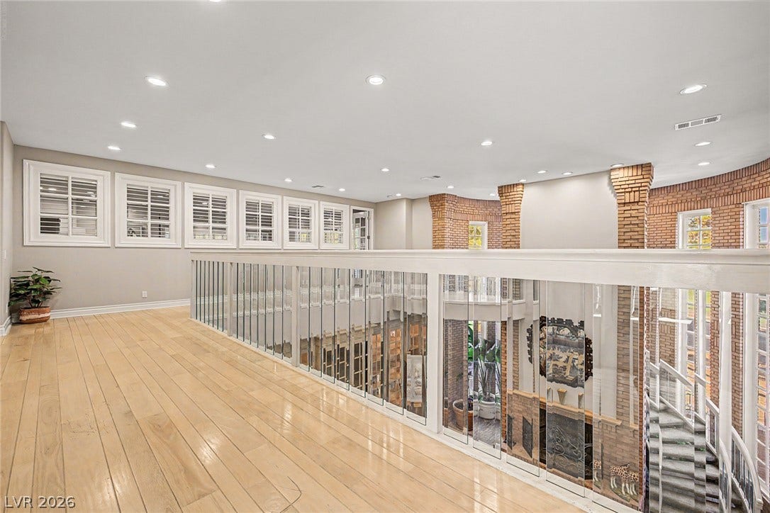 1105 Broadmoor Avenue, Las Vegas, NV 89109 Polished wood floors and a glass-paneled railing overlook the level below.