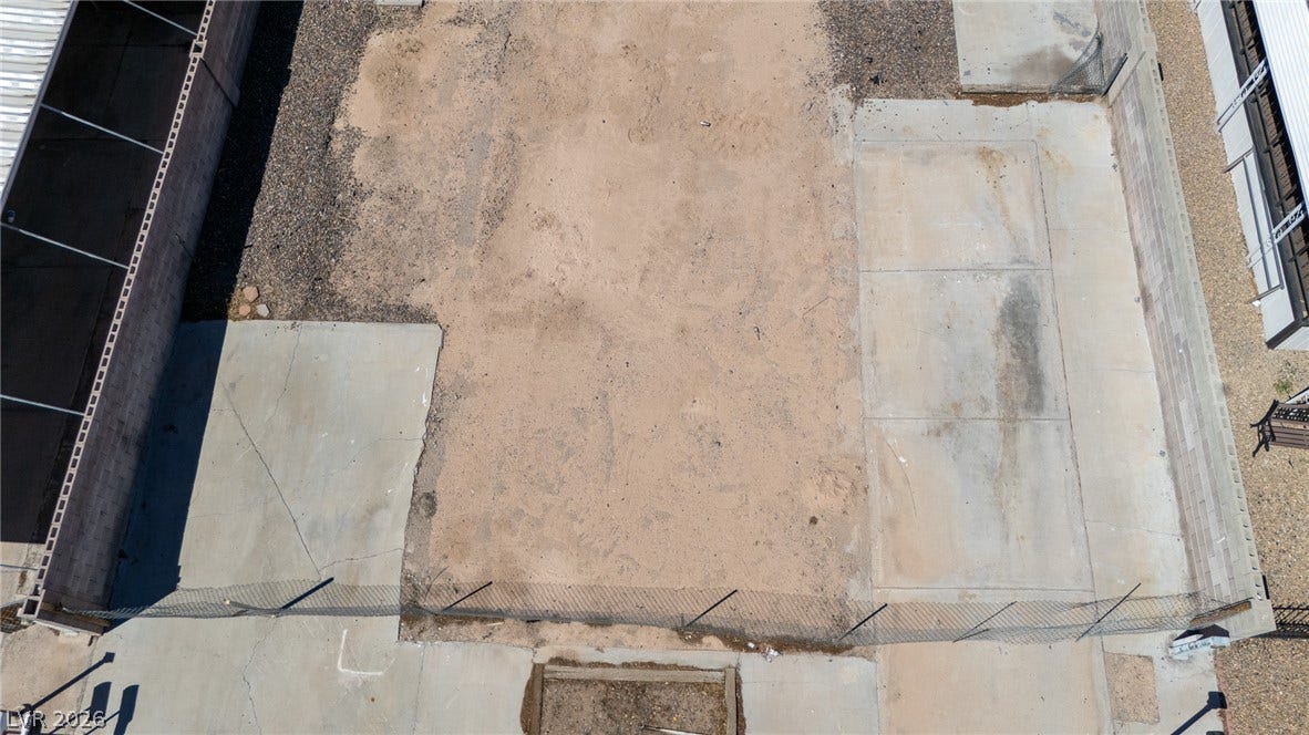 3499 Allegheny Drive, Las Vegas, NV 89122 An aerial view showcases a level, partially paved lot ready for development.