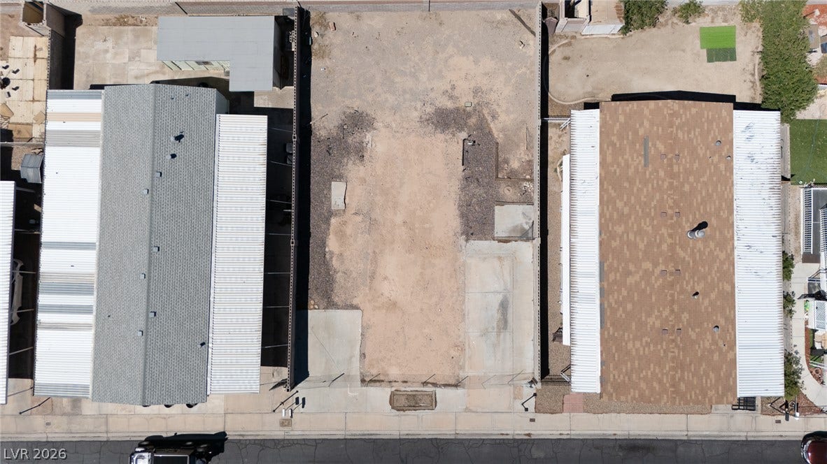 3499 Allegheny Drive, Las Vegas, NV 89122 A spacious vacant lot sits prepared for construction between existing residences.