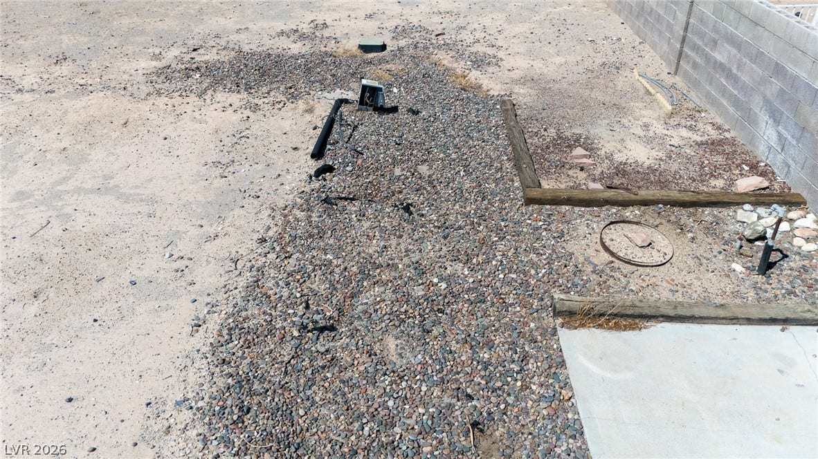 3499 Allegheny Drive, Las Vegas, NV 89122 A spacious desert yard bordered by a sturdy concrete block privacy wall.