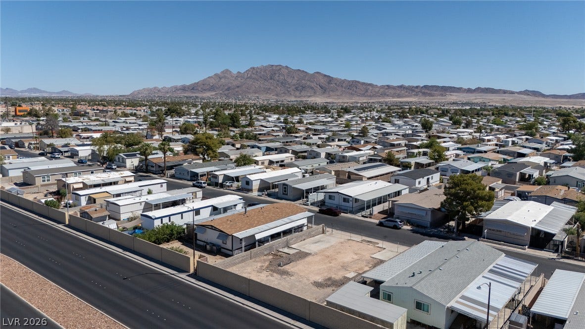 3499 Allegheny Drive, Las Vegas, NV 89122 An aerial perspective captures the vast neighborhood landscape set against a majestic mountain backdrop.