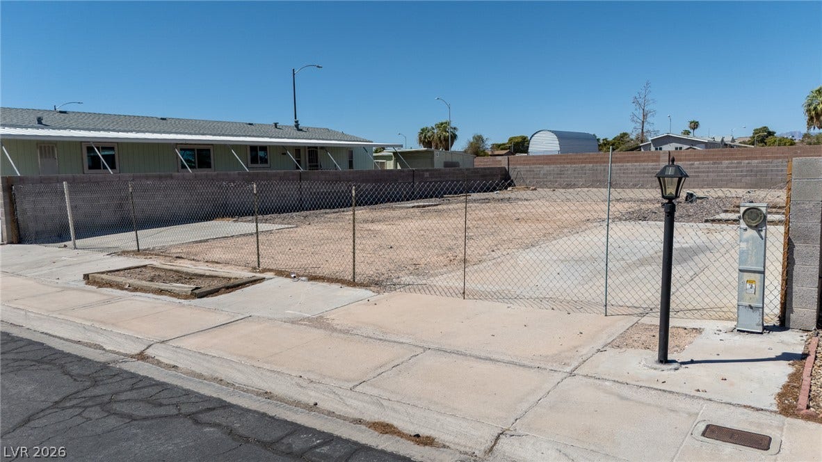 3499 Allegheny Drive, Las Vegas, NV 89122 An empty buildable lot comes fenced and lined by paved sidewalks.