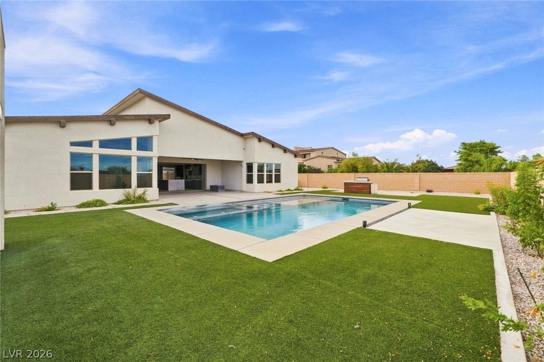 8380 Mojave Creek Court, Las Vegas, NV 89113 A sparkling swimming pool anchors the backyard alongside a spacious covered patio.