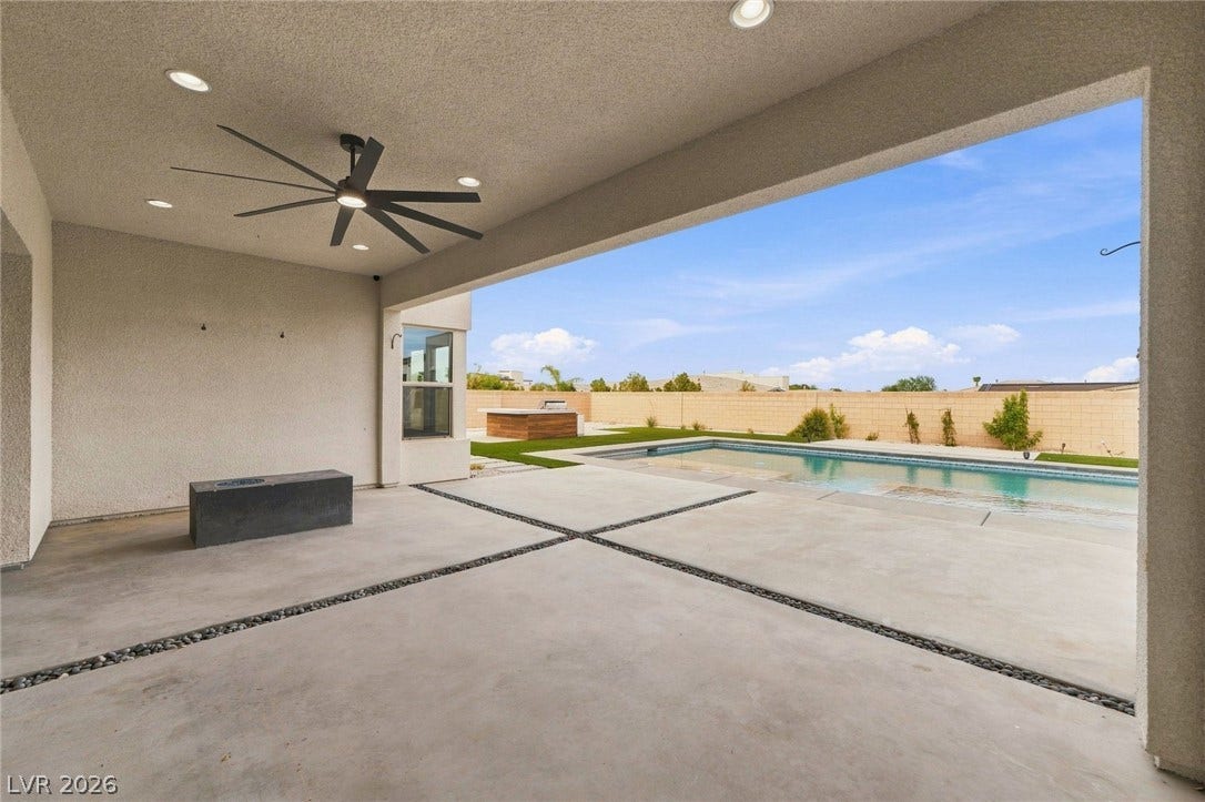8380 Mojave Creek Court, Las Vegas, NV 89113 A covered concrete terrace overlooks the private in-ground pool and backyard.