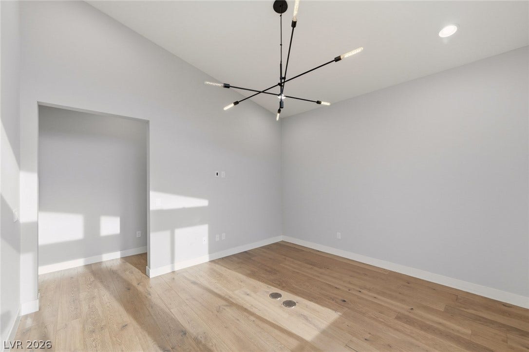 8380 Mojave Creek Court, Las Vegas, NV 89113 High ceilings and warm hardwood floors create an inviting and open ambiance.