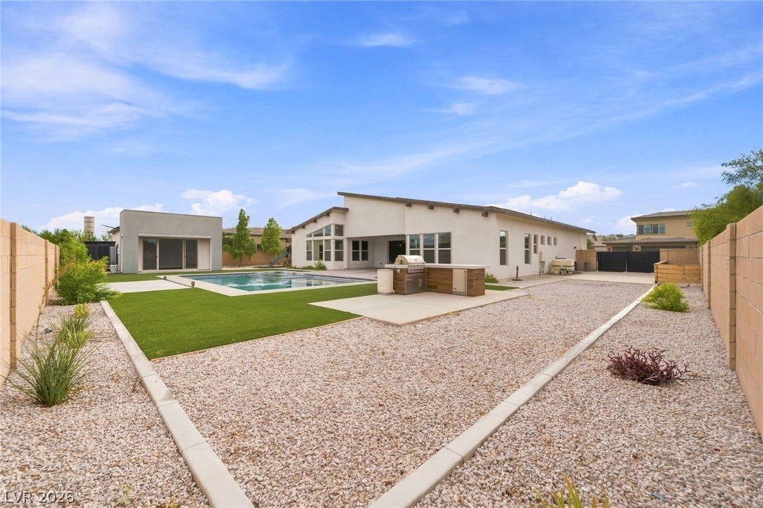 8380 Mojave Creek Court, Las Vegas, NV 89113 An inviting backyard oasis features a clean-lined pool, built-in barbecue station, and low-maintenance landscaping.