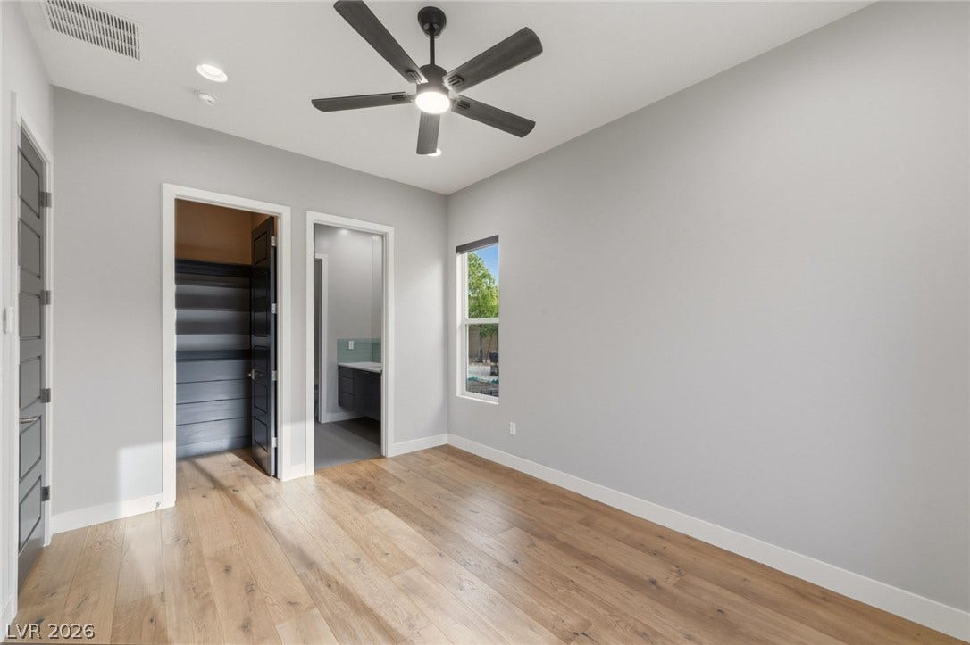 8380 Mojave Creek Court, Las Vegas, NV 89113 Rich wood flooring contrasts beautifully against smooth, clean-lined walls under a high ceiling.