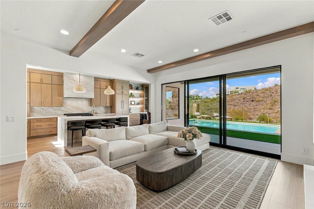 40 Stonemark Drive, Henderson, NV 89052 Massive sliding glass doors merge this open living space with the poolside patio.