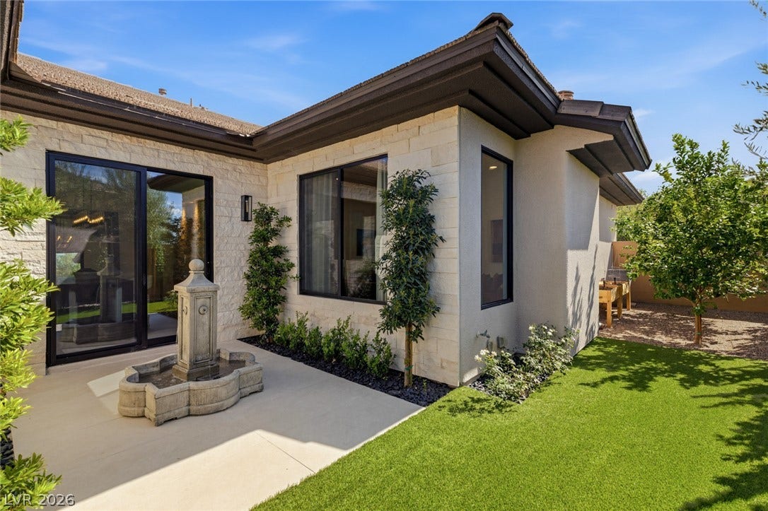 40 Stonemark Drive, Henderson, NV 89052 An inviting stone-accented courtyard features a stone fountain and manicured green lawn.
