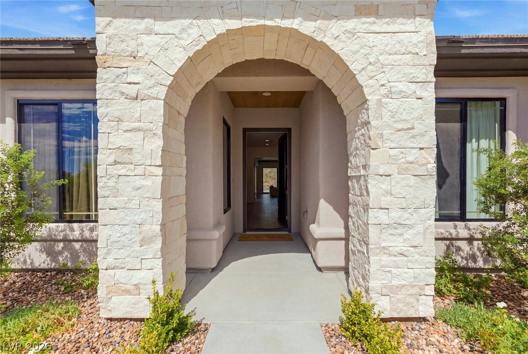 40 Stonemark Drive, Henderson, NV 89052 A grand stone archway frames the entry to this modern desert home.