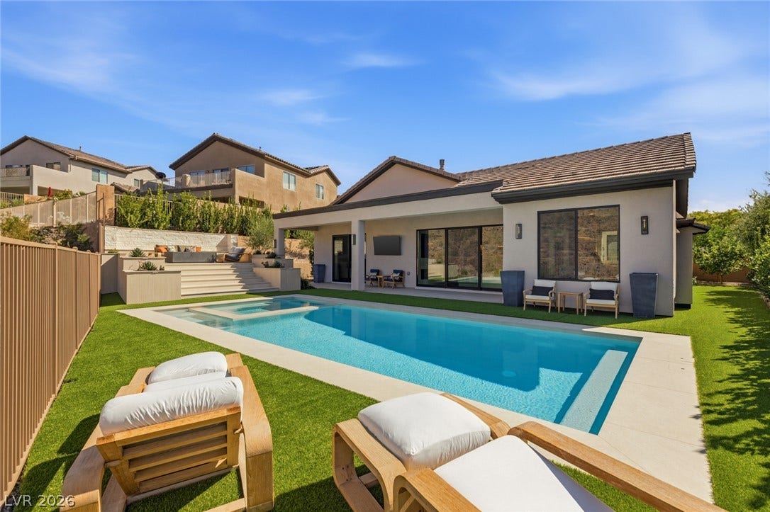 40 Stonemark Drive, Henderson, NV 89052 An inviting backyard oasis features a pristine swimming pool and a covered patio area.
