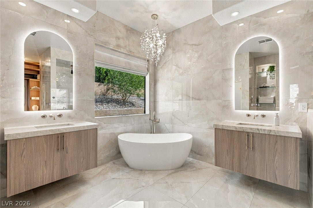40 Stonemark Drive, Henderson, NV 89052 Floor-to-ceiling tiling and a freestanding soaking tub create a luxurious spa-like retreat.