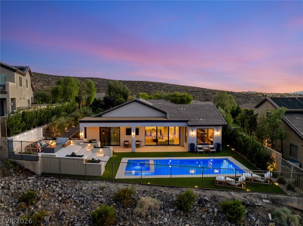 40 Stonemark Drive, Henderson, NV 89052 An inviting backyard oasis features a gleaming pool set against a backdrop of rolling hills.